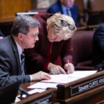 Sen. Curtis King discusses language in proposed legislation with Sen. Karen Keiser.